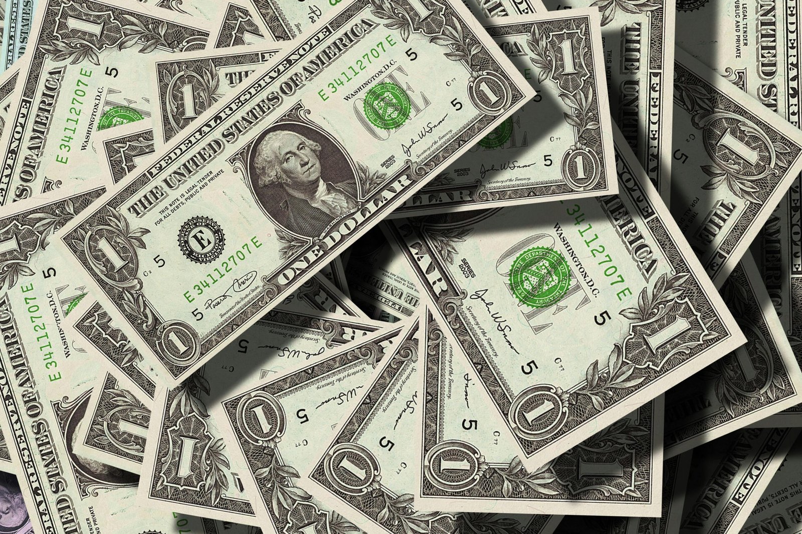 Close-up of scattered US dollar bills symbolizing finance and wealth.
