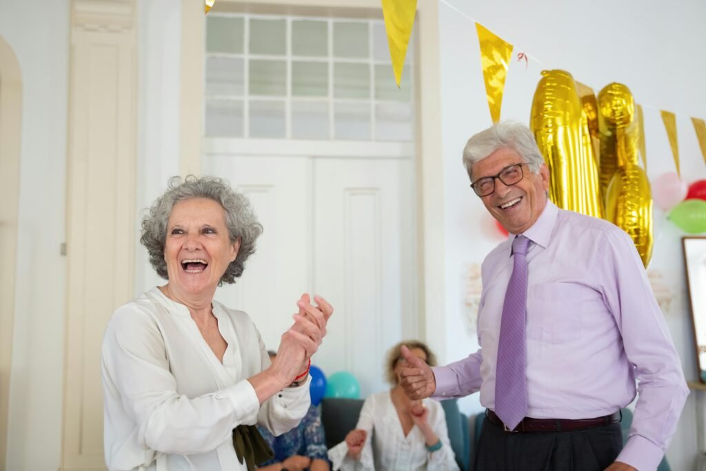 Happy seniors celebrating indoors with balloons and laughter. Perfect for festive and joyful lifestyle themes.